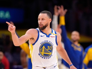 Golden State Warriors guard Stephen Curry left, gestures after scoring during the second half of an NBA basketball game against the Los Angeles Lakers, Thursday, April 3, 2025, in Los Angeles. (AP Photo/Mark J. Terrill)