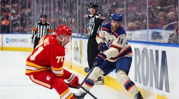 Hráč Edmontonu Oilers Mattias Ekholm (vpravo) strieľa cez Slováka Šimona Nemca z Calgary Flames v zápase zámorskej hokejovej NHL.