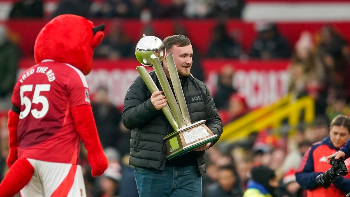 Luke Littler s trofejou na Old Trafford.