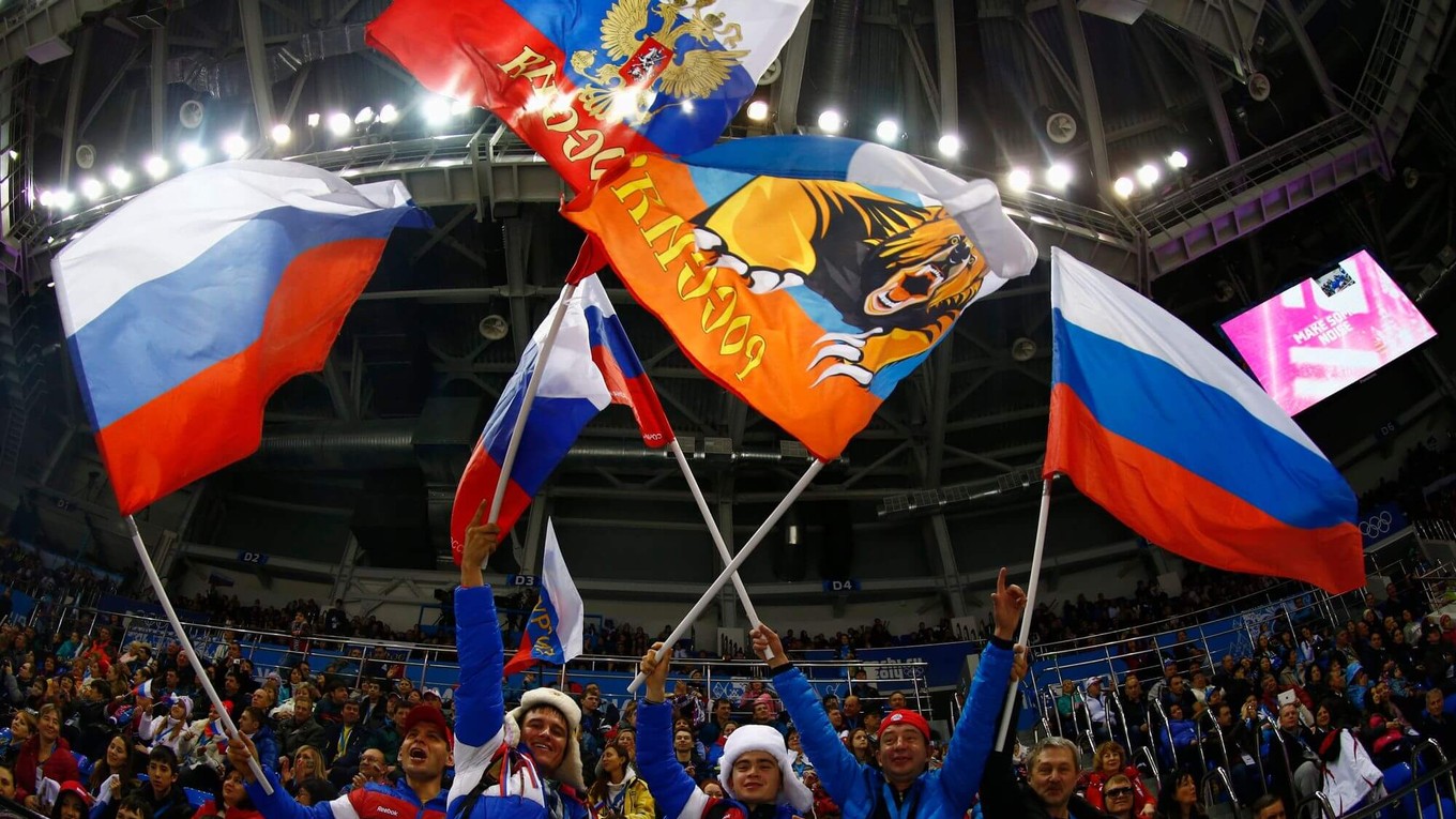 Hokejoví fanúšikovia s ruskými vlajkami na zimných hrách v Soči 2014. 