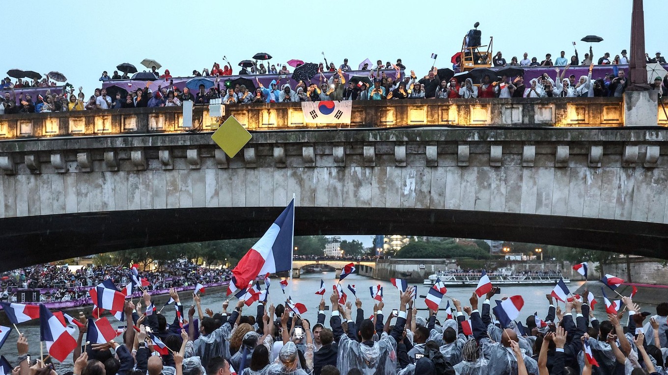 Francúzski športovci mávajú divákom počas otváracieho ceremoniálu LOH v Paríži 2024.