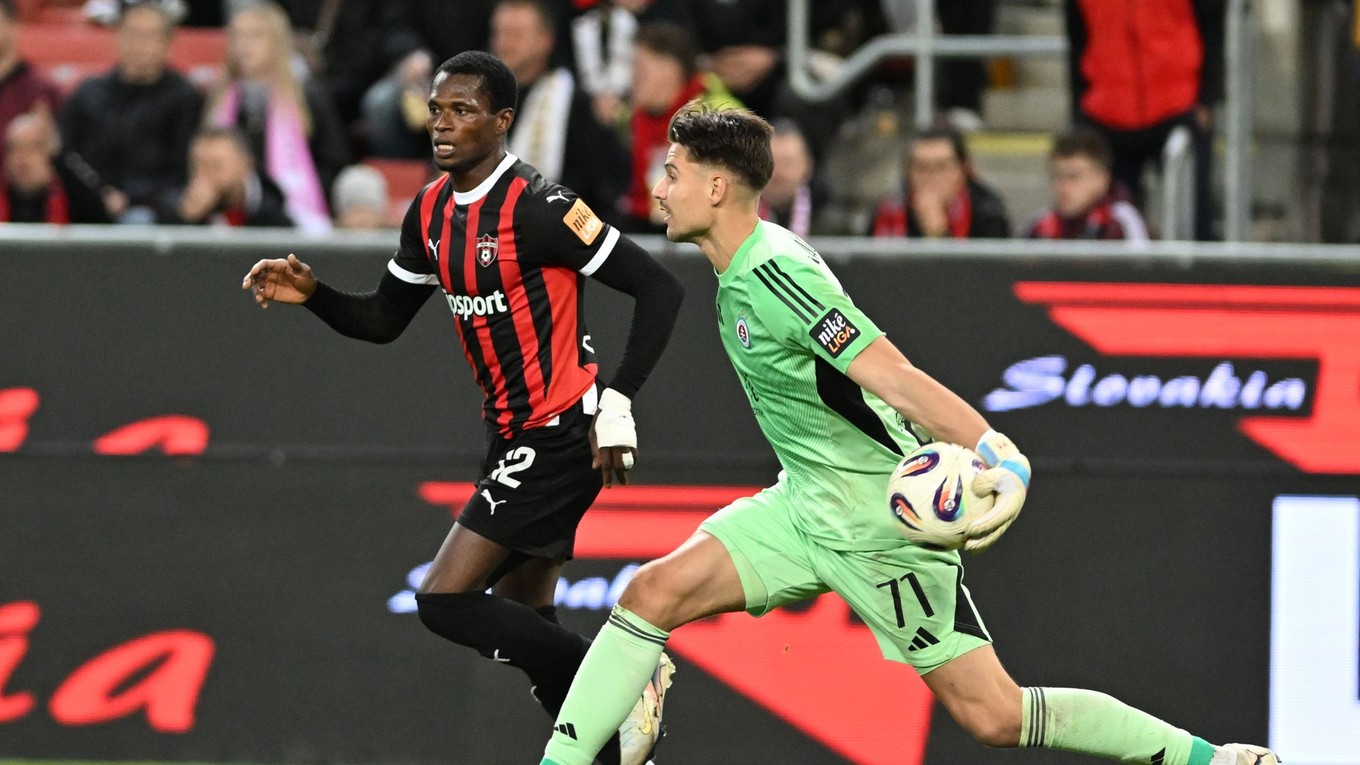 Sprava brankár Slovana Dominik Takáč a hráč Trnavy Abdulrahman Taiwo počas zápasu 11. kola Niké ligy medzi FC Spartak Trnava a ŠK Slovan Bratislava.