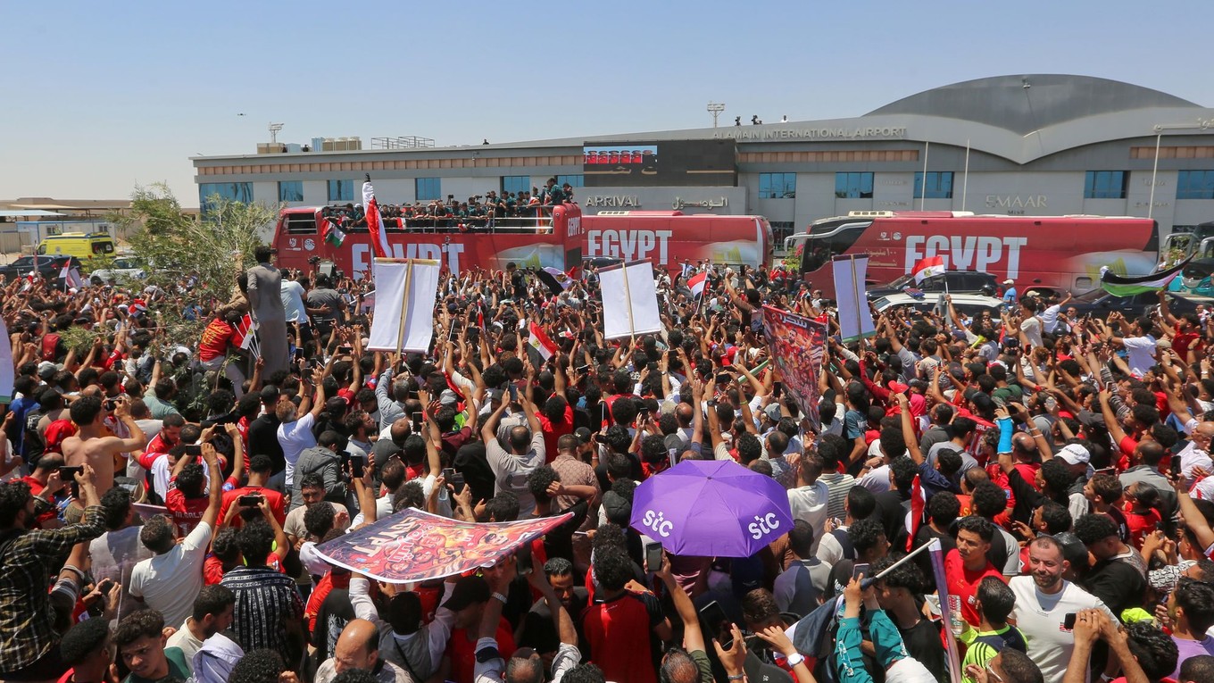 Fanúšikovia vítajú egyptskú futbalovú reprezentáciu po jej prílete na letisko El Alamein.