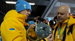 Ukrajinský skeletonista Vladislav Heraskevič drží svoju prilbu s vyobrazenými ukrajinskými športovcami.