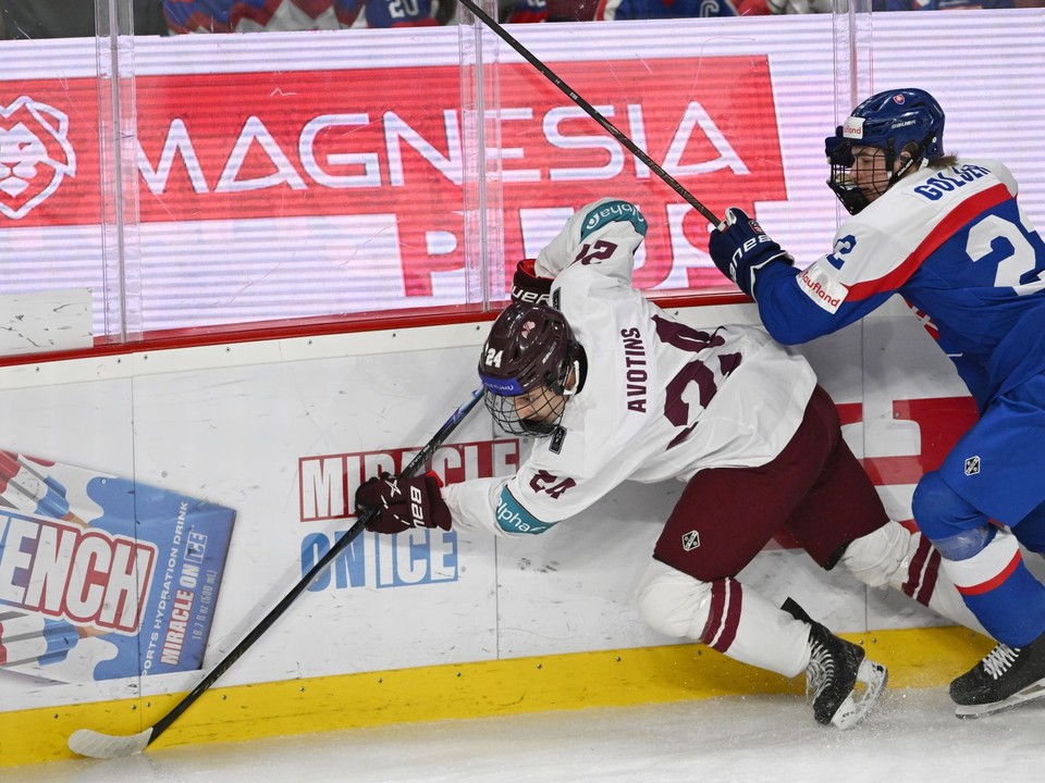 Na snímke vpravo kapitán Slovenska Adam Goljer a hráč Lotyšska Magnuss Avotins počas hokejového zápasu Slovensko – Lotyšsko v semifinále.
