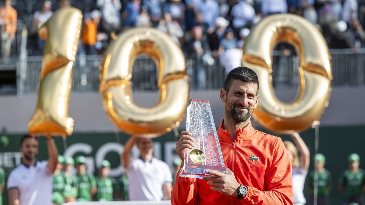 Novak Djokovič pózuje so 100. trofejou na okruhu ATP.