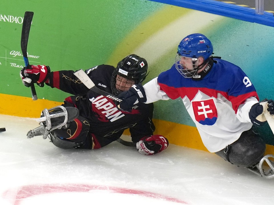 Japonský hráč Eiji Misawa (vľavo) a slovenský hráč Dávid Korman v zápase B-skupiny v parahokeji Slovensko - Japonsko.