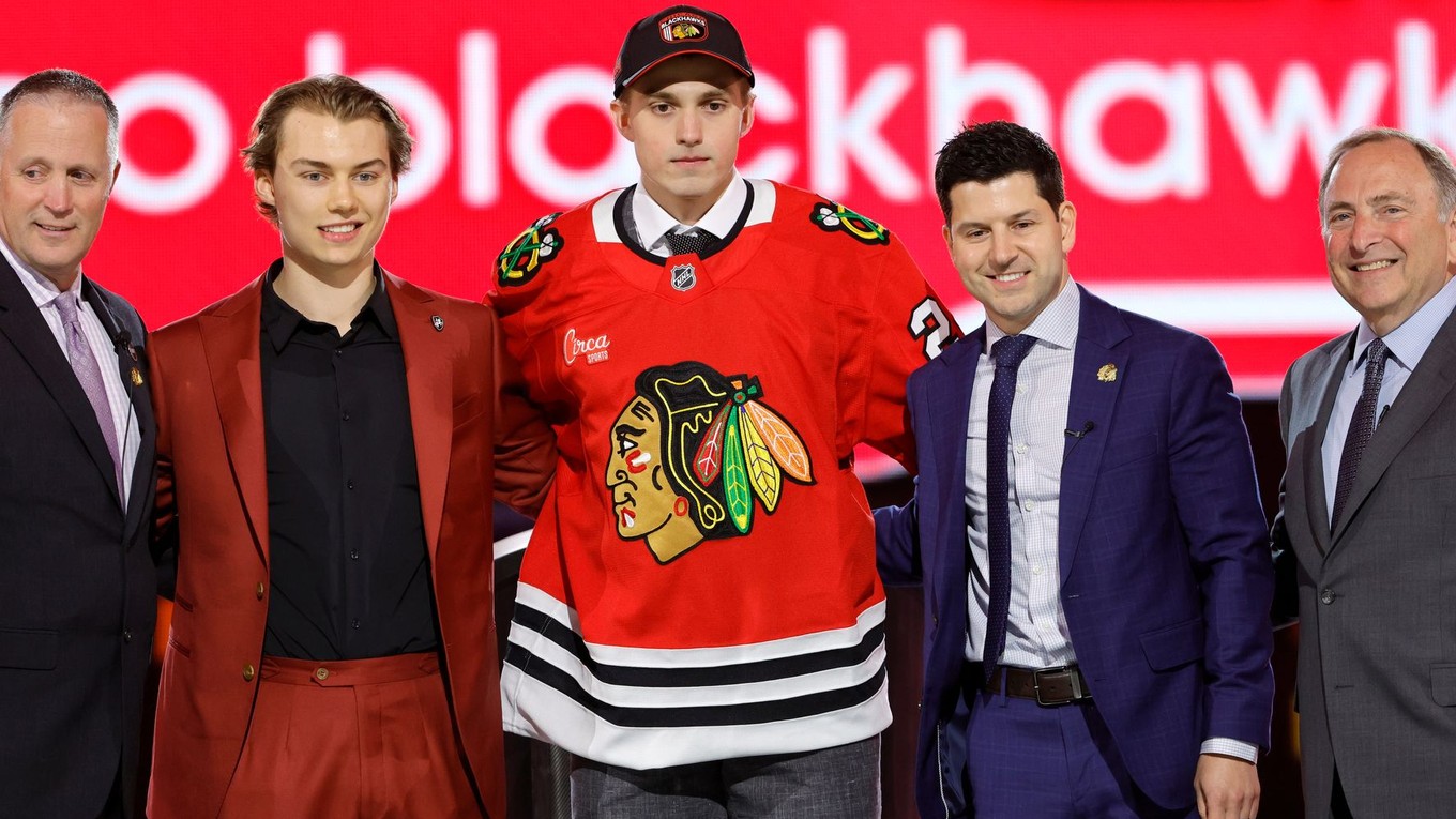 Artyom Levshunov, center, poses after being selected by the Chicago Blackhawks during the first round of the NHL hockey draft Friday, June 28, 2024, in Las Vegas. (AP Photo/Steve Marcus)

- Artyom Levshunov