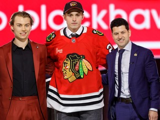 Artyom Levshunov, center, poses after being selected by the Chicago Blackhawks during the first round of the NHL hockey draft Friday, June 28, 2024, in Las Vegas. (AP Photo/Steve Marcus)

- Artyom Levshunov