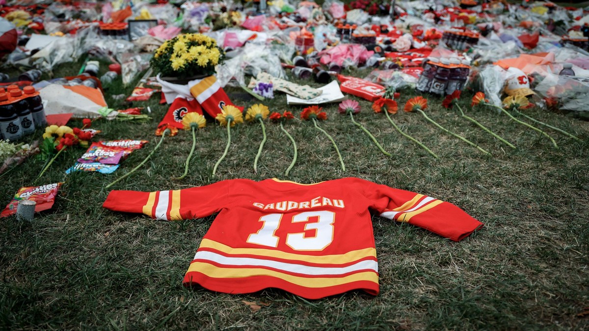 Flowers and memorabilia for former Calgary Flames player Johnny Gaudreau and his brother Matthew lie on the grass outside the Saddledome in Calgary, Alberta, Wednesday, Sept. 4, 2024. (Jeff McIntosh/The Canadian Press via AP)

- Canada;Canadian;NHL;athletes;competing;competitive;fans;game;games;ice hockey;memorial;mourn;mourners;nhl2024;nhl202409;nhl20240904;nhl24;nhl240904;physical;play;puck;rink;sport;sporting;sports;stick;vigil