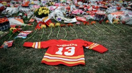 Flowers and memorabilia for former Calgary Flames player Johnny Gaudreau and his brother Matthew lie on the grass outside the Saddledome in Calgary, Alberta, Wednesday, Sept. 4, 2024. (Jeff McIntosh/The Canadian Press via AP)

- Canada;Canadian;NHL;athletes;competing;competitive;fans;game;games;ice hockey;memorial;mourn;mourners;nhl2024;nhl202409;nhl20240904;nhl24;nhl240904;physical;play;puck;rink;sport;sporting;sports;stick;vigil