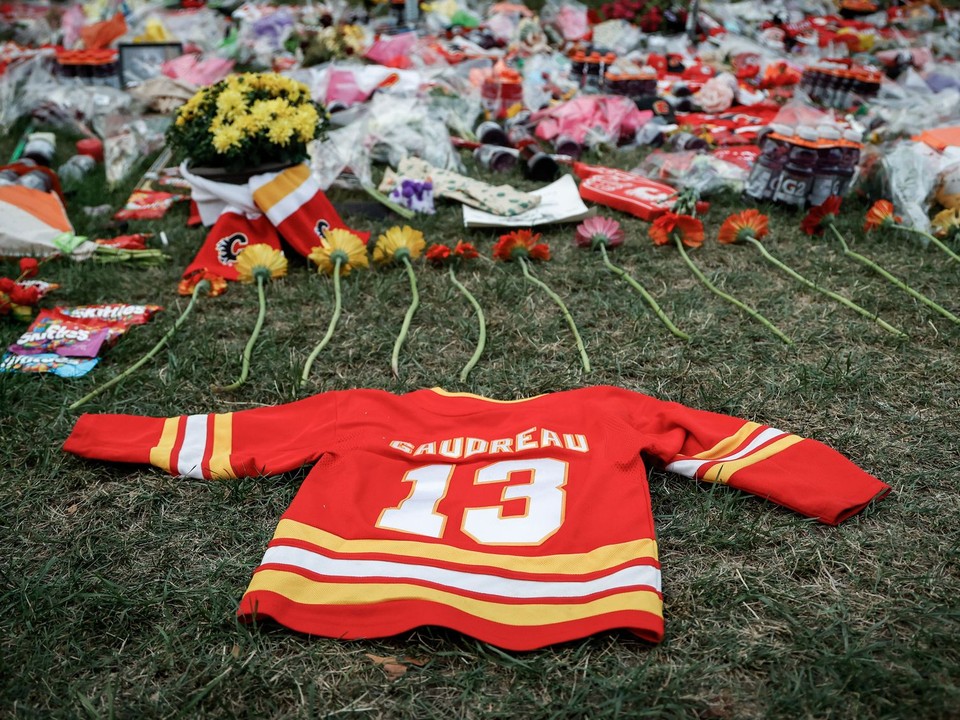 Flowers and memorabilia for former Calgary Flames player Johnny Gaudreau and his brother Matthew lie on the grass outside the Saddledome in Calgary, Alberta, Wednesday, Sept. 4, 2024. (Jeff McIntosh/The Canadian Press via AP)

- Canada;Canadian;NHL;athletes;competing;competitive;fans;game;games;ice hockey;memorial;mourn;mourners;nhl2024;nhl202409;nhl20240904;nhl24;nhl240904;physical;play;puck;rink;sport;sporting;sports;stick;vigil