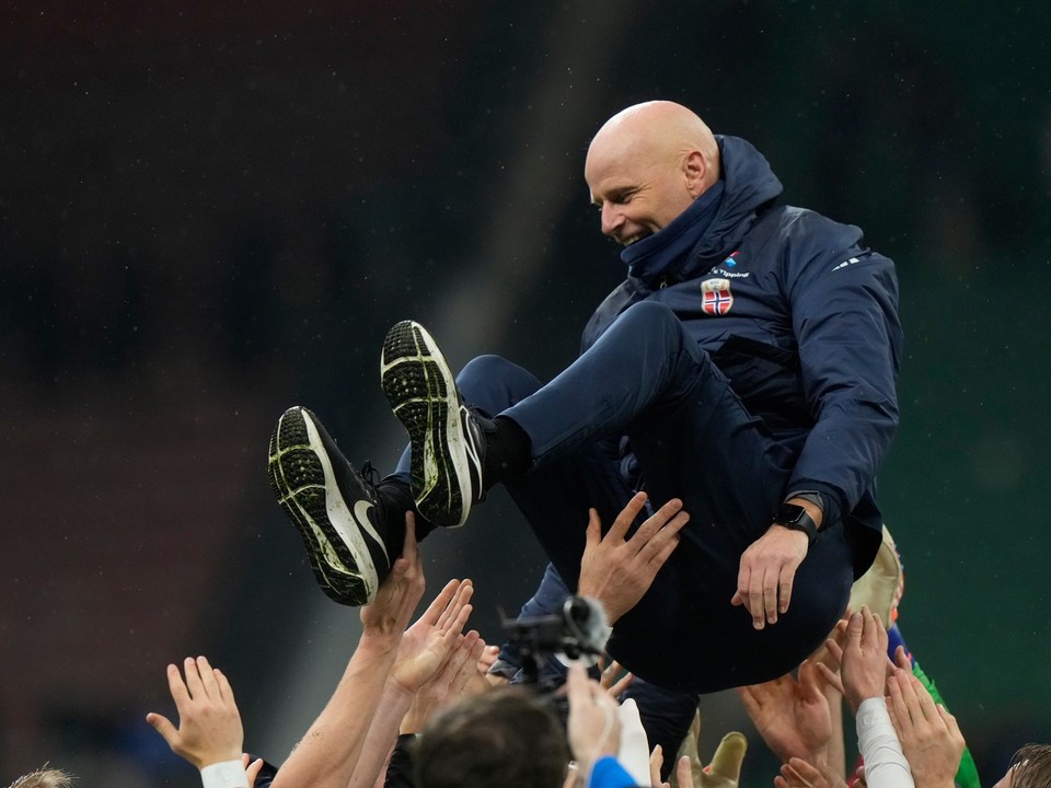 Nórski futbalisti vyhadzujú nad hlavy trénera Staaleho Solbakkena po postupe na MS 2026. 