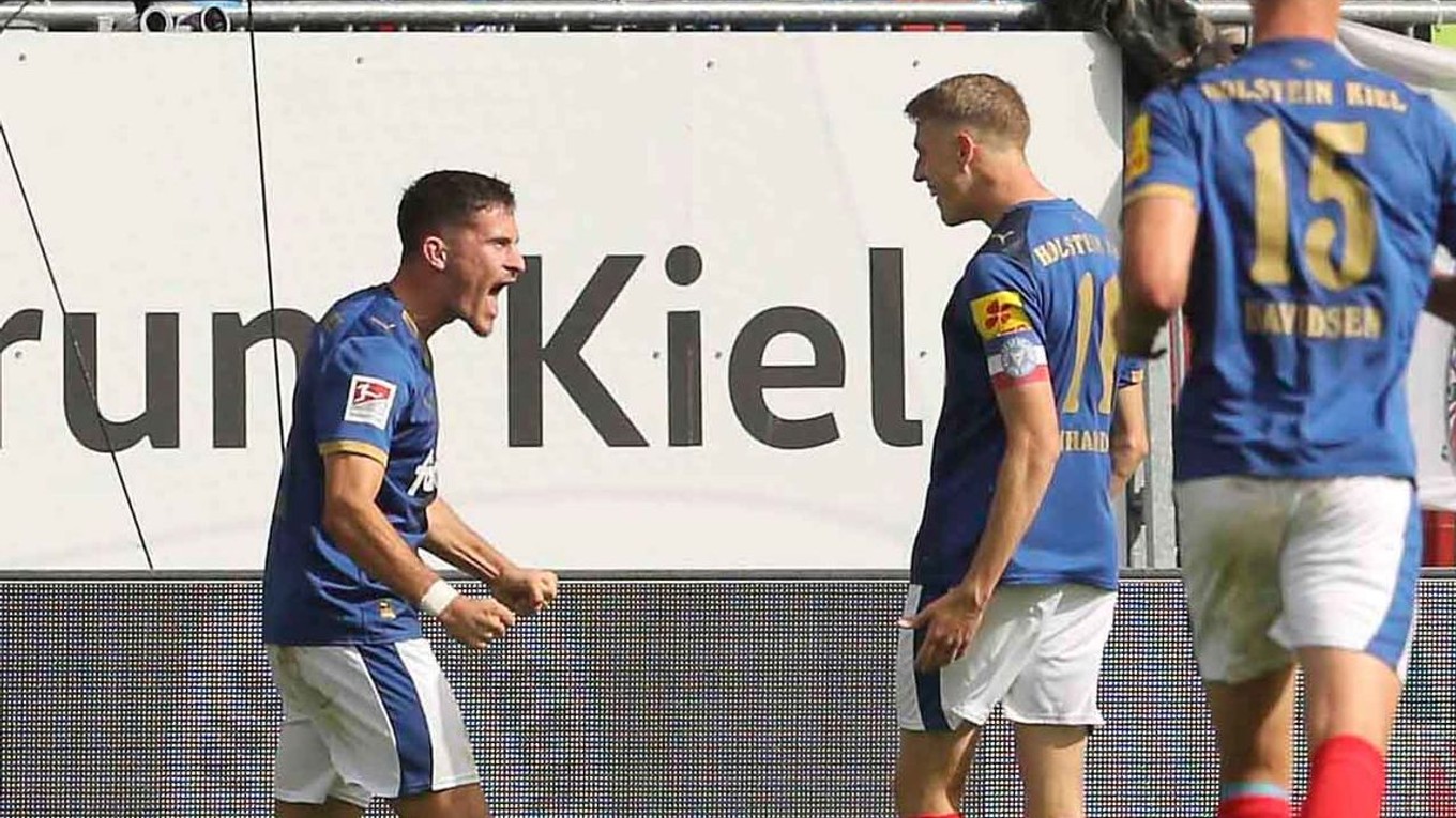 Slovenský futbalista v drese Kielu Adrián Kaprálik (vľavo) sa teší so spoluhráčmi z gólu v zápase 6. kola druhej nemeckej Bundesligy Holstein Kiel - Karlsruher SC.