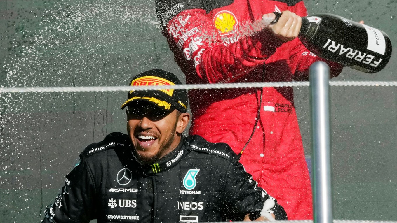 Pretekár tímu Ferrari Charles Leclerc strieka šampanské na Lewisa Hamiltona. 