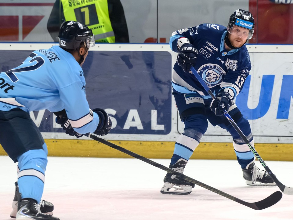 Sena Acolatse (Slovan) a Michal Krištof (Nitra) v prvom zápase finále play off Tipsport extraligy medzi HK Nitra a HC Slovan Bratislava.