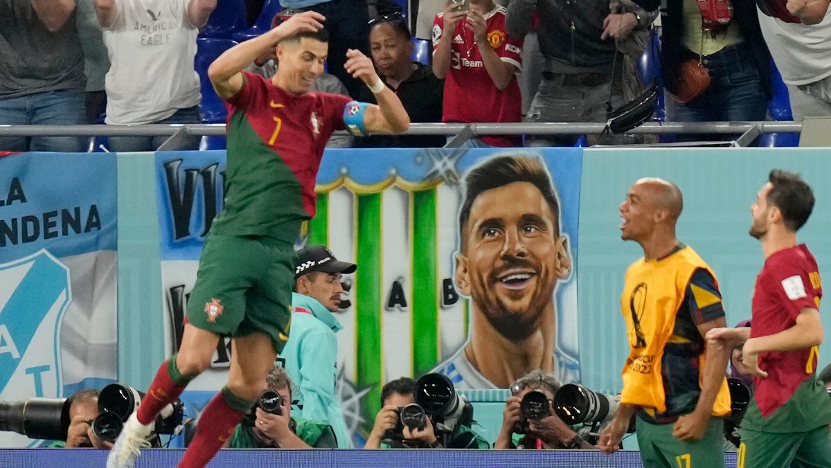 Cristiano Ronaldo sa teší z jediného gólu na MS vo futbale 2022 vedľa transparentu, na ktorom je Lionel Messi.