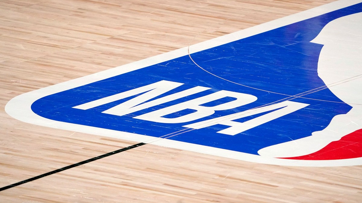 FILE -  The NBA logo at center court is shown during the second half of an NBA first-round playoff basketball game between the Houston Rockets and Oklahoma City Thunder in Lake Buena Vista, Fla., Wednesday, Sept. 2, 2020. The NBA has agreed to terms on its new media deal, an 11-year agreement worth $76 billion that assures player salaries will continue rising for the foreseeable future and one that will surely change how some viewers access the game for years to come. (AP Photo/Mark J. Terrill, File)

- NBA;basketball;sports;restart;Men's basketball;Men's sports;NBA basketball;Professional basketball
