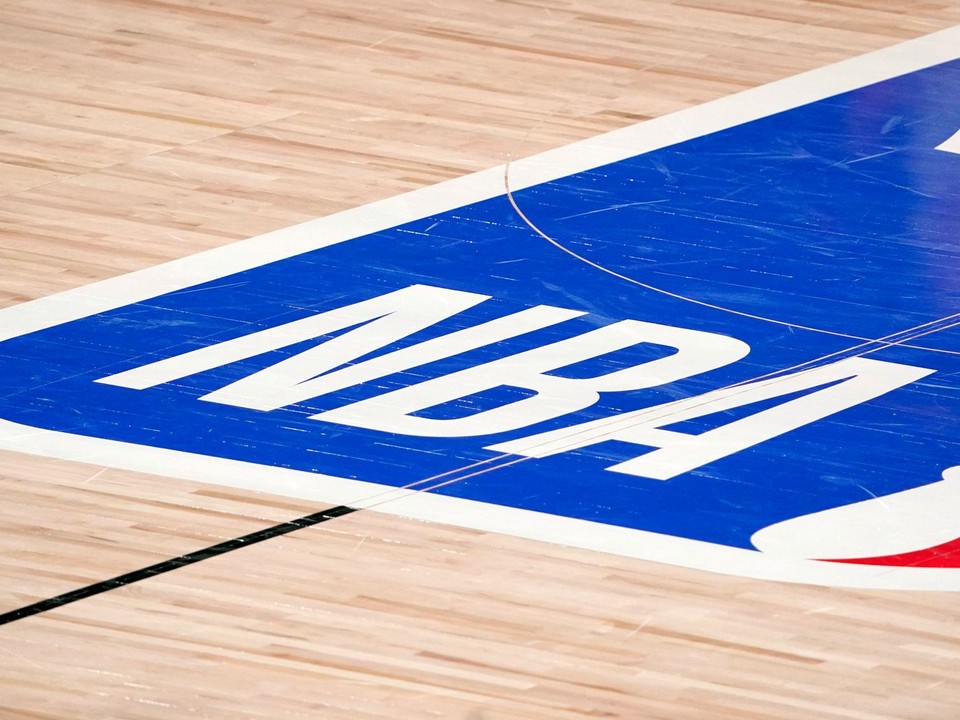 FILE -  The NBA logo at center court is shown during the second half of an NBA first-round playoff basketball game between the Houston Rockets and Oklahoma City Thunder in Lake Buena Vista, Fla., Wednesday, Sept. 2, 2020. The NBA has agreed to terms on its new media deal, an 11-year agreement worth $76 billion that assures player salaries will continue rising for the foreseeable future and one that will surely change how some viewers access the game for years to come. (AP Photo/Mark J. Terrill, File)

- NBA;basketball;sports;restart;Men's basketball;Men's sports;NBA basketball;Professional basketball