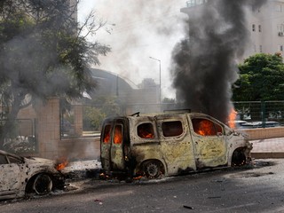 Horiace autá na ulici po tom, ako ich zasiahli rakety vystrelené z pásma Gazy v izraelskom meste Aškelon. 