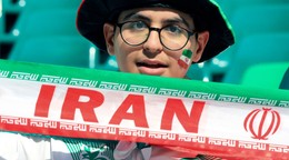 FILE - An Iranian fan holds his national team banner prior to the Asian Cup quarterfinal soccer match between Japan and Iran at Education City Stadium in Al Rayyan, Qatar, Feb. 3, 2024. (AP Photo/Hussein Sayed, file)
