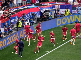 Serbia players exercise in front of their fans during warmup before a Group C match between Slovenia and Serbia at the Euro 2024 soccer tournament in Munich, Germany, Thursday, June 20, 2024. (AP Photo/Ariel Schalit)

- XEURO2024X