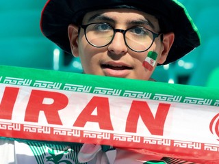 FILE - An Iranian fan holds his national team banner prior to the Asian Cup quarterfinal soccer match between Japan and Iran at Education City Stadium in Al Rayyan, Qatar, Feb. 3, 2024. (AP Photo/Hussein Sayed, file)