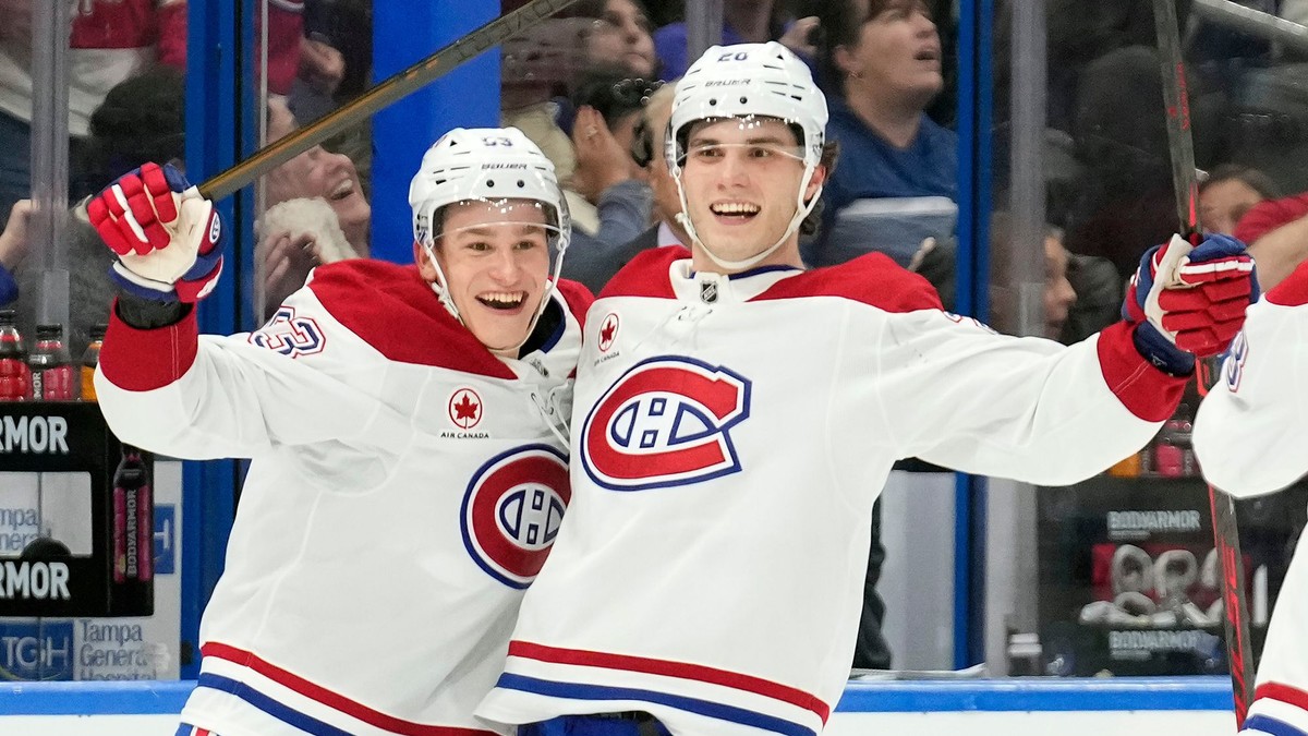 Hráč Montrealu Ivan Demidov (vľavo) sa teší z gólu, ktorý strelil slovenský hokejista a jeho spoluhráč Juraj Slafkovský (vpravo).