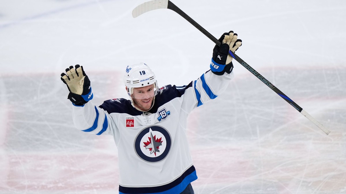 Center tímu Winnipeg Jets Jonathan Toews máva divákom počas zápasu NHL na ľade Chicago Blackhawks.