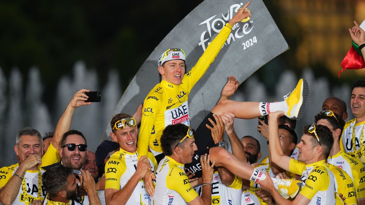 Víťaz Tour de France 2024 Tadej Pogačar oslavuje s tímovými kolegami. 