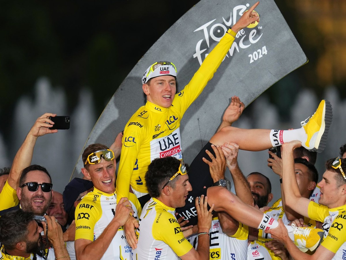 Víťaz Tour de France 2024 Tadej Pogačar oslavuje s tímovými kolegami. 