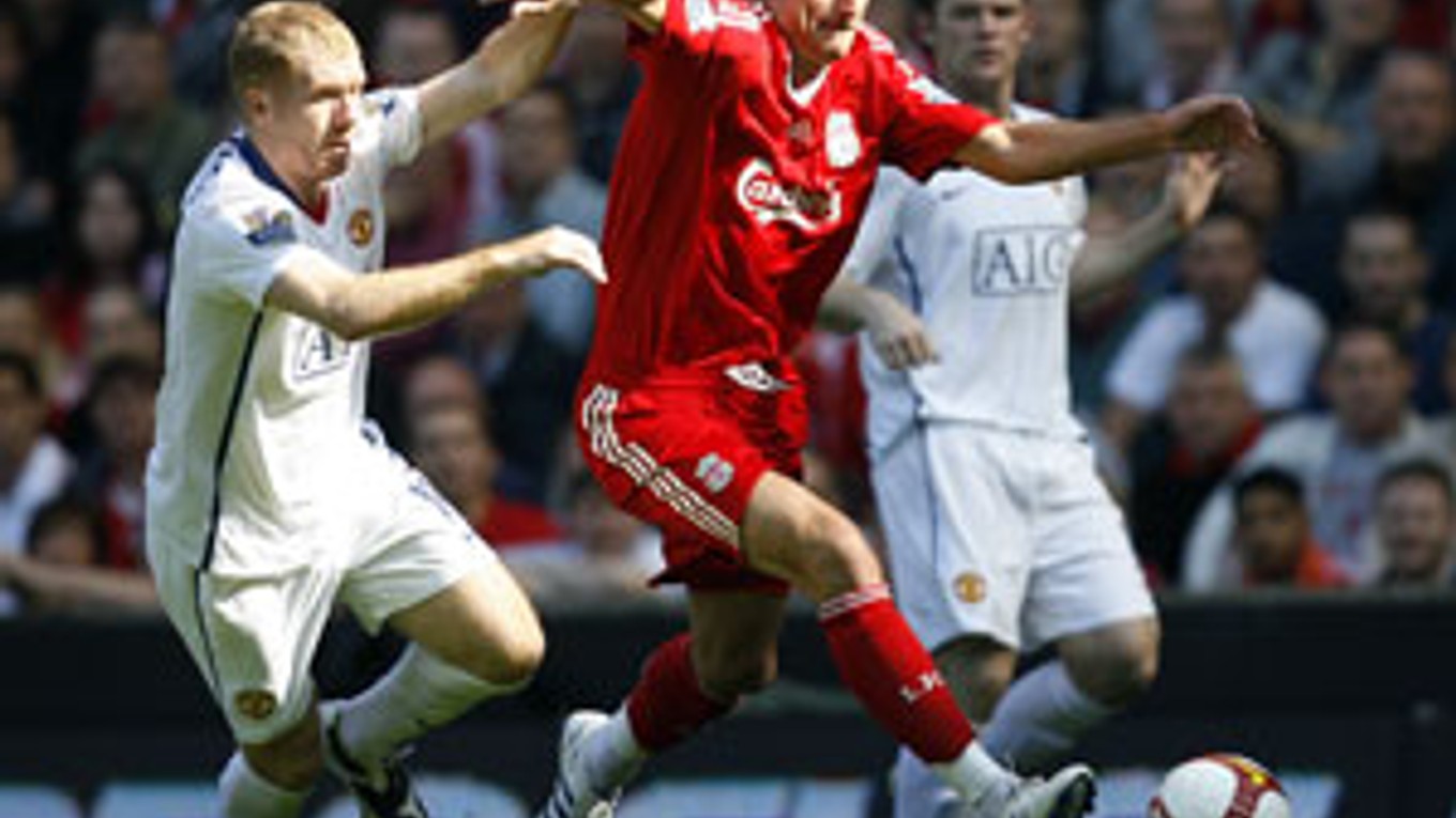 Albert Riera z Liverpoolu v súboji s Paulom Scholesom z Manchester United.