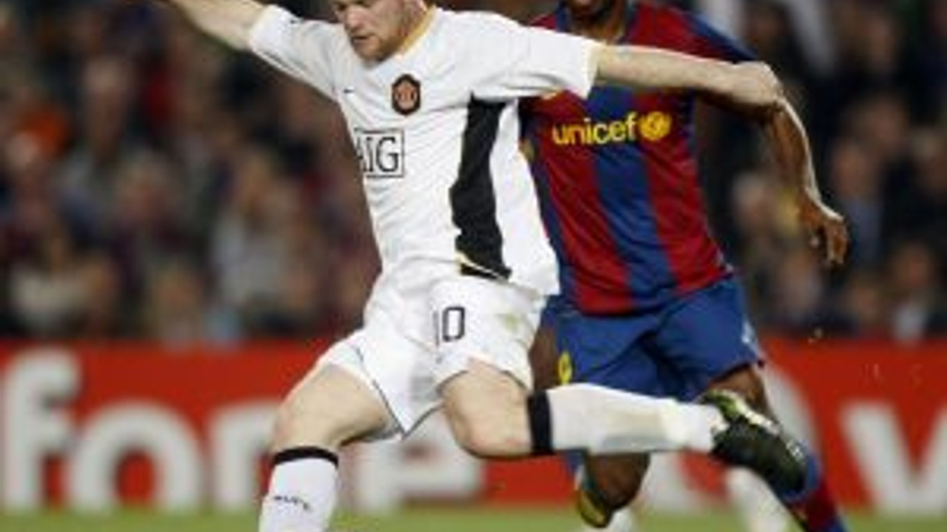 Útočník Manchestru United Wayne Rooney (vľavo) zakončuje pred Samuelom Eto´om z Barcelony.