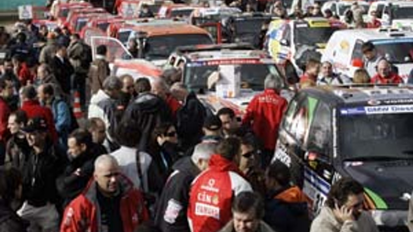 Šéf Rely Dakar Etienne Lavigne (na snímke dolu) smúti po správe, ktorú musel oznámiť účastníkom podujatia.  Na snímke hore pretekári pri svojich vozidlách rozoberajú nečakanú zvesť.