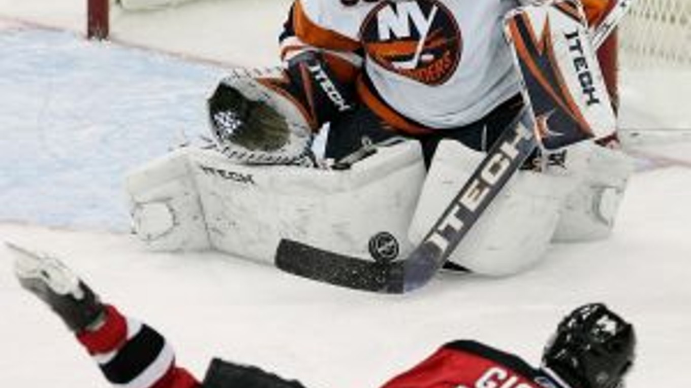 Brankár New York Islanders Rick DiPietro (39) zasahuje po pokuse hráča New Jersey Devils Briana Giontu (14).