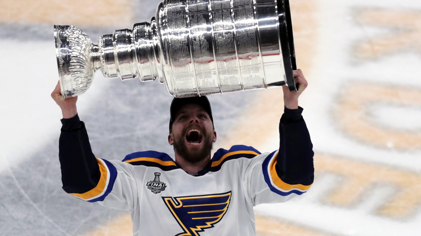 Hokejista St. Louis Blues David Perron zdvíha nad hlavu Stanley Cup pre víťaza NHL 2018/2019.
