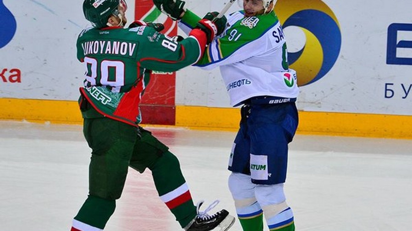 Súboj kazaňského Arťoma Lukojanova (vľavo) s Maximom Saprykinom z Ufy. Hokejisti Kazane zatiaľ v sérii prehráva a klub bude musieť navyše zaplatiť pokutu.