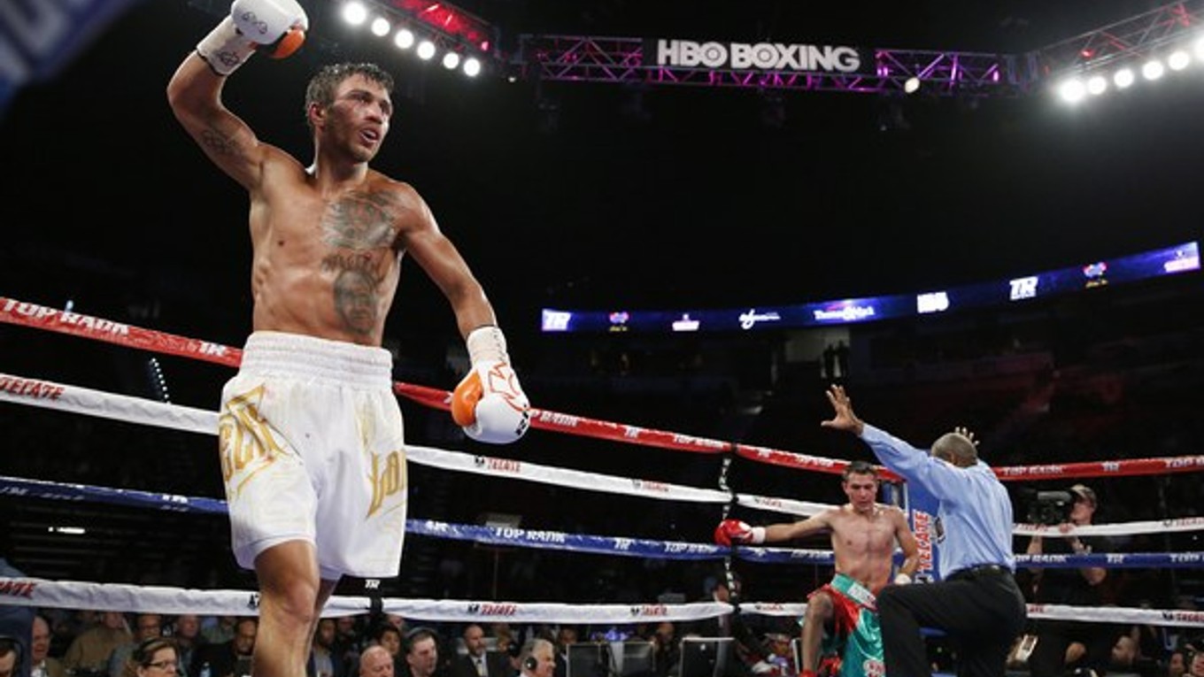 Ukrajinec Vasiľ Lomačenko (vľavo) sa teší z úspešnej obhajoby titulu profesionálnej verzie WBO v perovej hmotnostnej kategórii po víťazstve nad Mexičanom Romulom Koasichom.