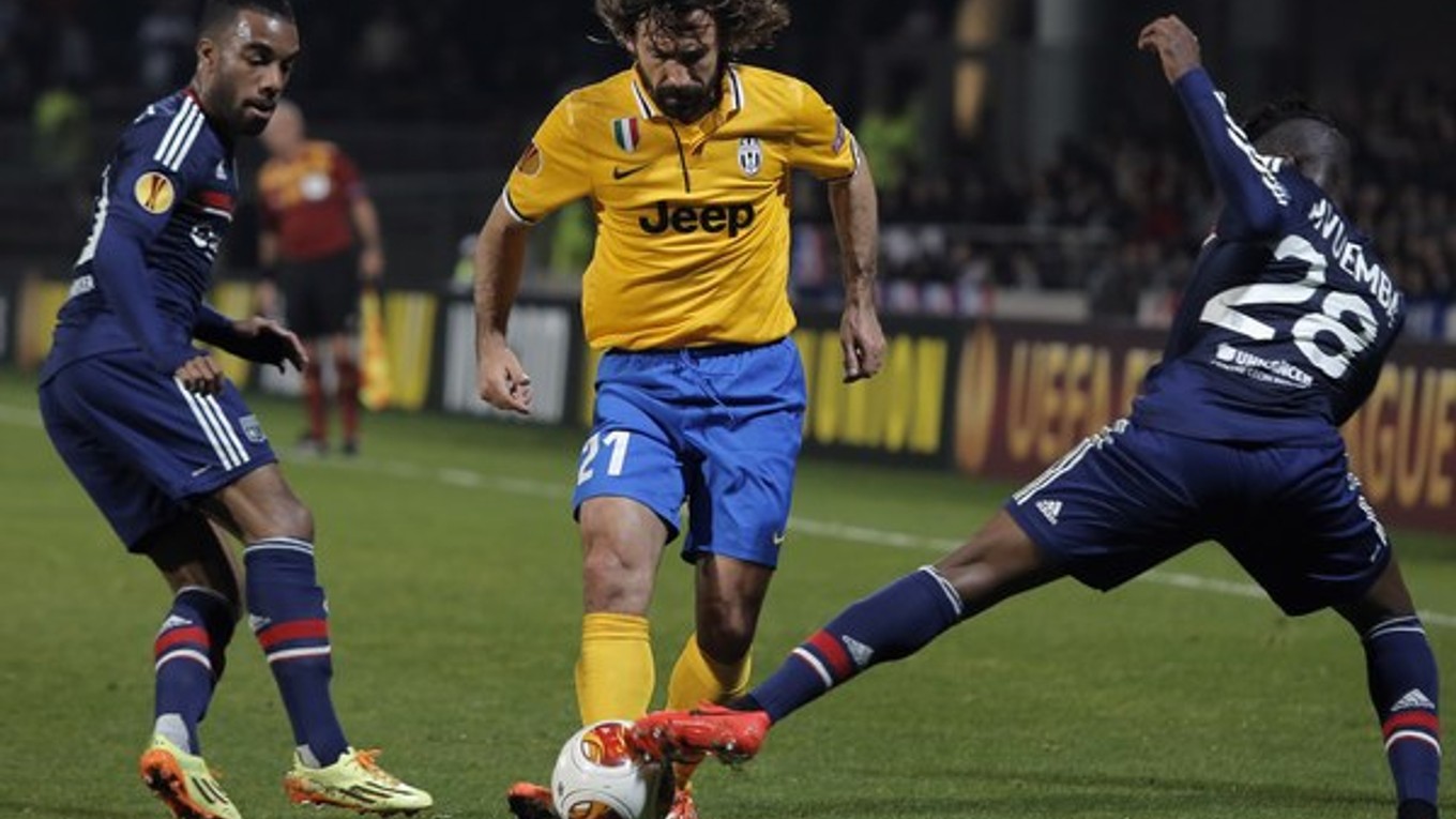 Pirlo (v strede) v súboji s dvomi hráčmi Lyonu.