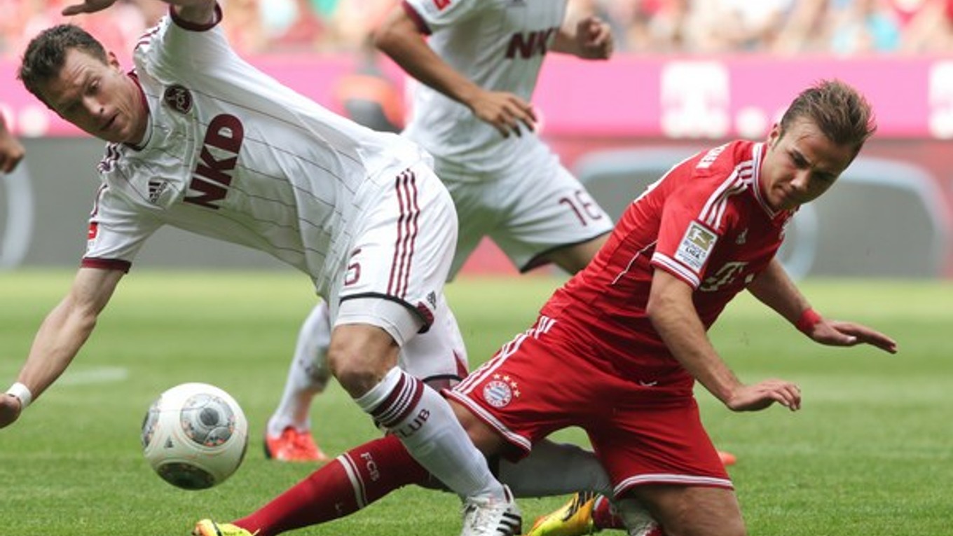 Futbalista Norimbergu Niklas Stark (vľavo) a hráč Bayernu Mníchov Mario Götze bojujú o loptu v zápase bundesligy.