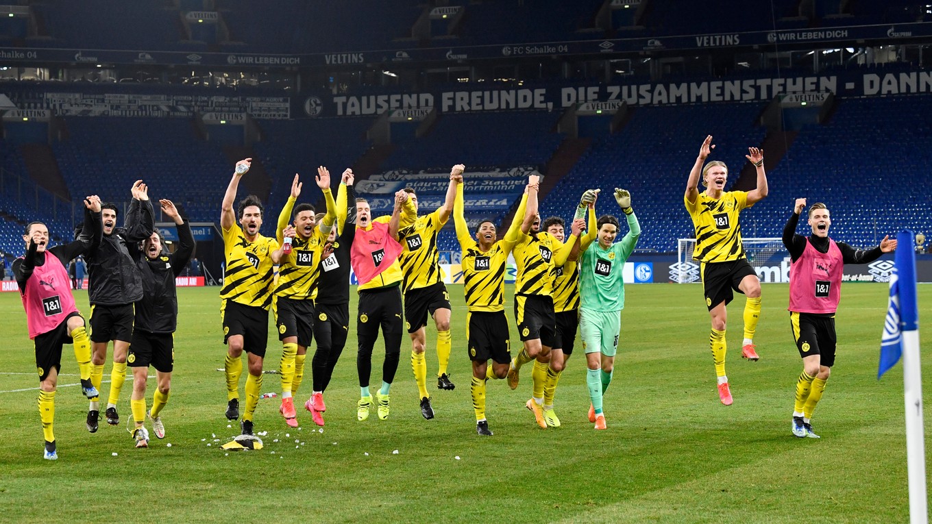 Hráči Dortmundu oslavujú na konci futbalového zápasu.