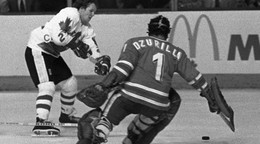 Kanadský útočník Darryl Sittler prekonáva brankára Vladimíra Dzurillu v predĺžení druhého finále Kanadského pohára 1976. Kanada zdolala ČSSR 5:4 pp.