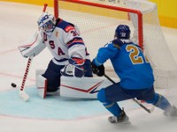 Unted States' goalkeeper Alex Nedeljkovic, left, makes a save in front of Kazakhstan's Kirill Panyukov during the preliminary round match between United States and Kazakhstan at the Ice Hockey World Championships in Ostrava, Czech Republic, Sunday, May 19, 2024. (AP Photo/Darko Vojinovic)