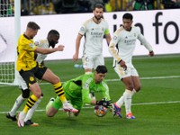 Real Madrid's goalkeeper Thibaut Courtois makes a save during the Champions League final soccer match between Borussia Dortmund and Real Madrid at Wembley stadium in London, Saturday, June 1, 2024. (AP Photo/Dave Shopland)

- XCHAMPIONSLEAGUEX