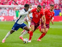 England's Bukayo Saka, left, and Switzerland's Ricardo Rodriguez challenge for the ball during a quarterfinal match between England and Switzerland at the Euro 2024 soccer tournament in Duesseldorf, Germany, Saturday, July 6, 2024. (AP Photo/Darko Vojinovic)

- XEURO2024X