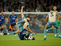 Manchester City's Josko Gvardiol, left, is challenged by Inter Milan's Marcus Thuram during the Champions League opening phase soccer match between Manchester City and Inter Milan at the Etihad Stadium, in Manchester, England, Wednesday, Sept. 18, 2024. (AP Photo/Dave Thompson)

- XCHAMPIONSLEAGUEX