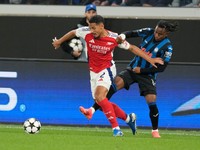 Arsenal's William Saliba, left, and Atalanta's Ademola Lookman challenge for the ball during the Champions League opening phase soccer match between Atalanta and Arsenal at the Bergamo's stadium in Bergamo, Italy, Thursday, Sept. 19, 2024. (AP Photo/Antonio Calanni)

- XCHAMPIONSLEAGUEX