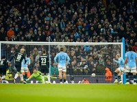 Manchester City's Erling Haaland scores the opening goal from the penalty spot during the Champions League opening phase soccer match between Manchester City and Feyenoord at the Etihad Stadium in Manchester, England, Tuesday, Nov. 26, 2024. (AP Photo/Dave Thompson)