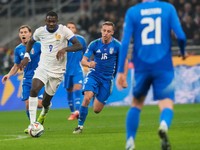 France's Marcus Thuram, second from left, challenges for the ball with Italy's Nicolo Barella, left, and Davide Frattesi during the Nations League soccer match between Italy and France, at the San Siro stadium in Milan, Italy, Sunday, Nov. 17, 2024. (AP Photo/Luca Bruno)

- XFRIENDLYX