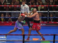 Boxers Britain's Tyson Fury, right, and Ukraine's Oleksandr Usyk compete during their WBA, WBO, and WBC world heavyweight title fight in Riyadh, Saudi Arabia, Saturday, Dec. 21, 2024. (AP Photo/Frank Augstein)